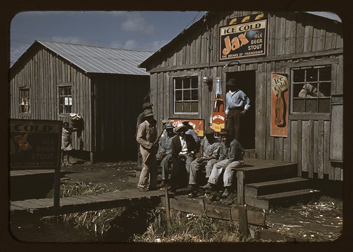 A 1941 photo taken for a Farm Security Administration project shows migrant workers on a break  in Belle Glade, Fla.