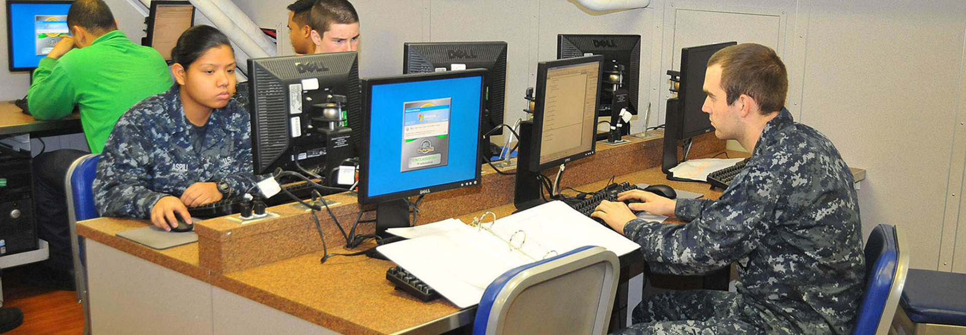Sailors use computers in the Learning Media Resource Center to check personal email aboard the aircraft carrier USS Carl Vinson.