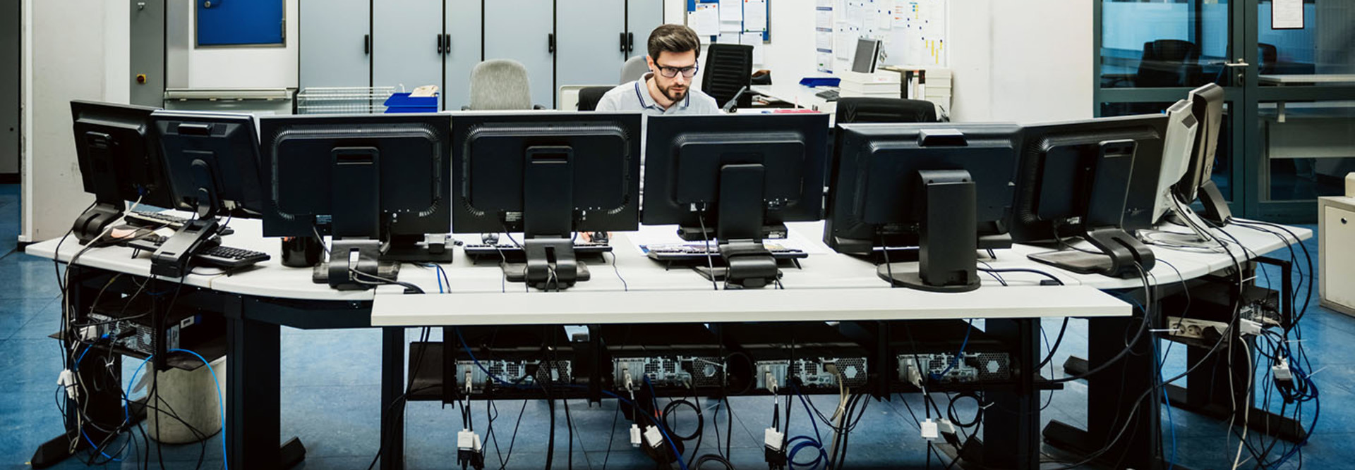 guy at workstation with like 1000 computers