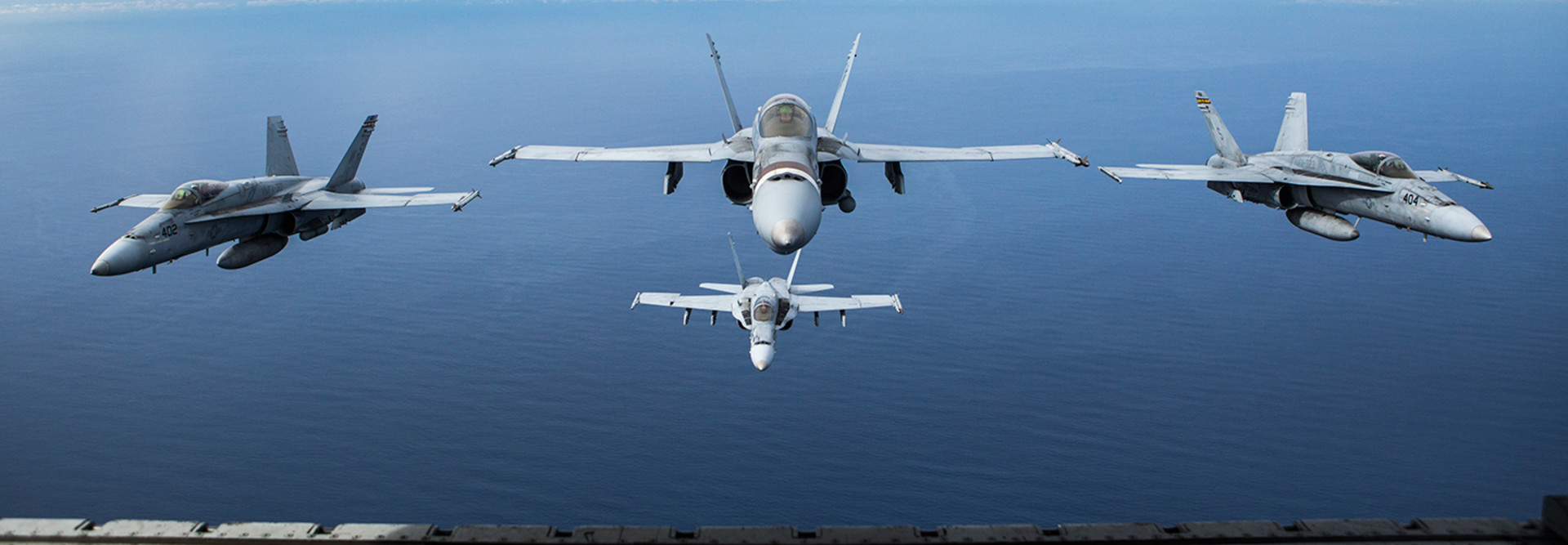 Four F/A-18C Hornets assigned to Marine Fighter Attack Squadron 323 fly in formation behind a KC-130J Super Hercules attached to Marine Aerial Refueler Transport Squadron 352, Marine Aircraft Group 11, during a readiness exercise called the ‘Elephant Walk’ above Marine Corps Air Station Miramar, Calif., Feb. 1, 2019.