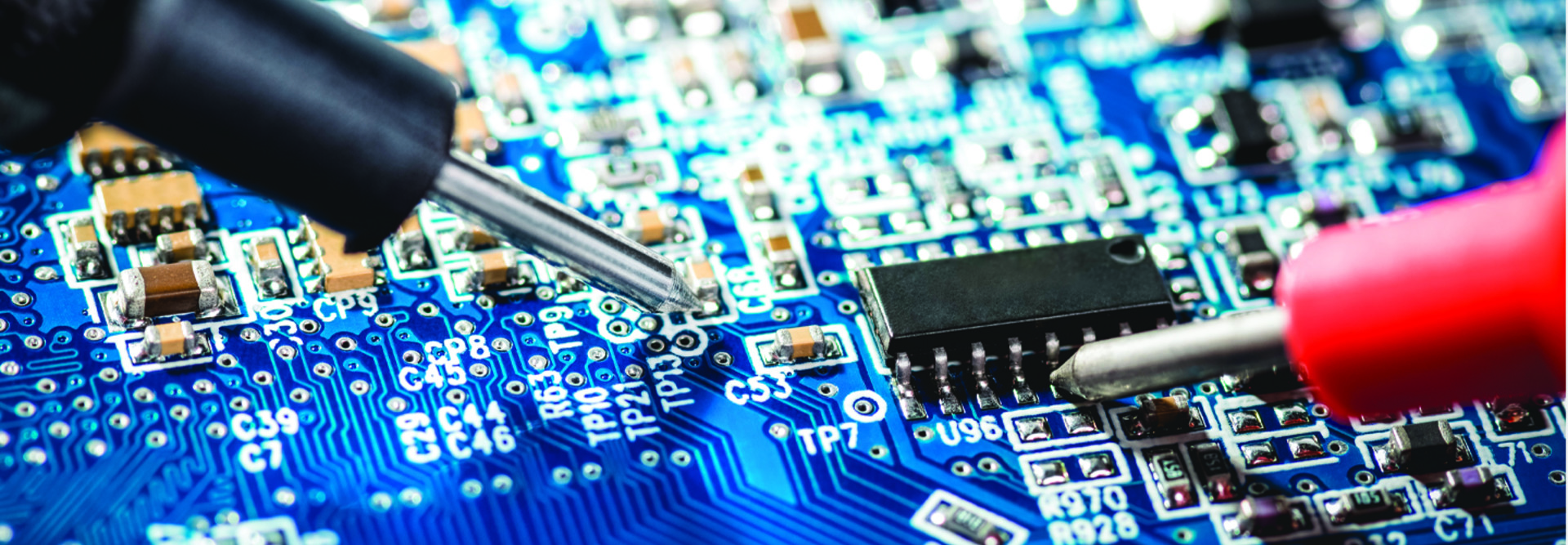 Closeup of screwdrivers working on a computer motherboard
