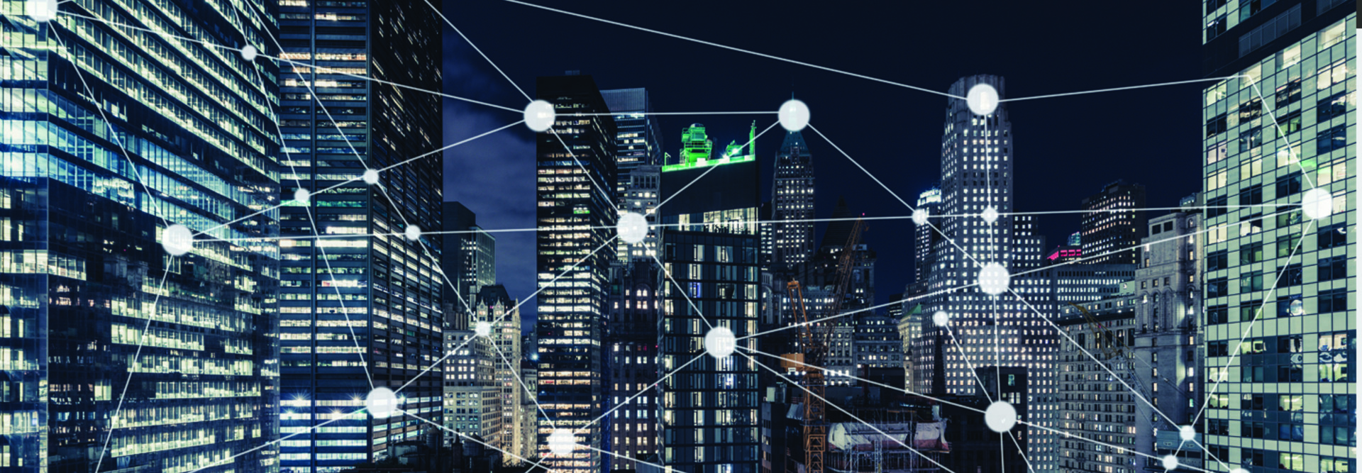 City at night with lines linking buildings to indicate networks
