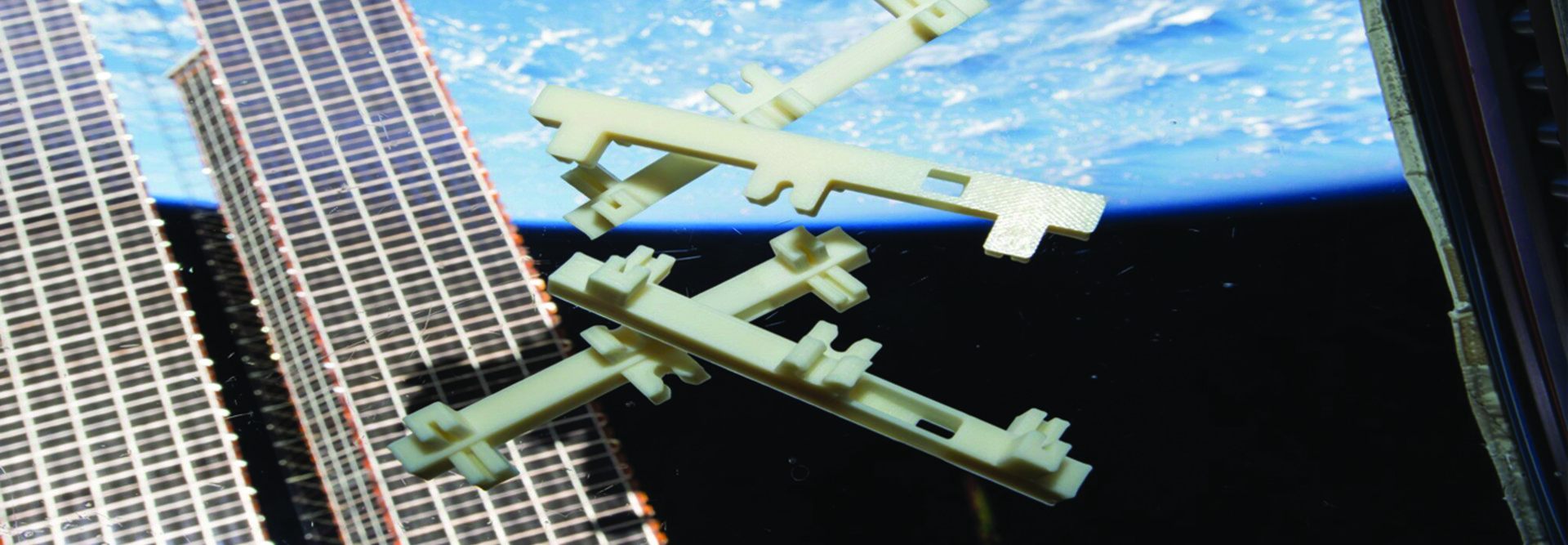 White plastic structures floating in space against the Earth