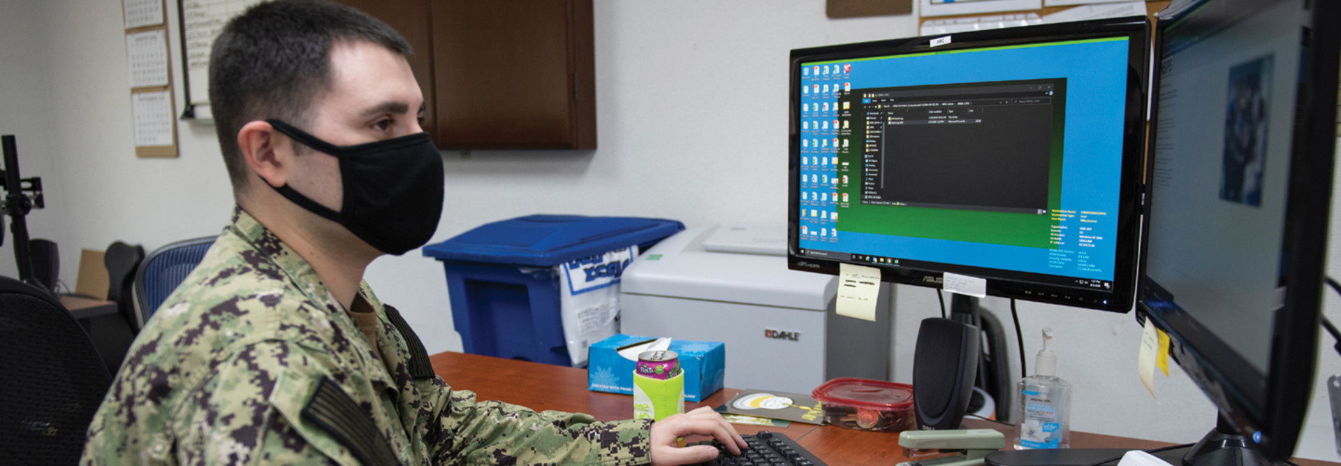 Yeoman 2nd Class Niko Counce, assigned to Commander, Fleet Activities Okinawa, verifies Sailor's information using the Navy Standard Integrated Personnel System on Kadena Air Base in Okinawa, Japan, Aug. 5, 2020.