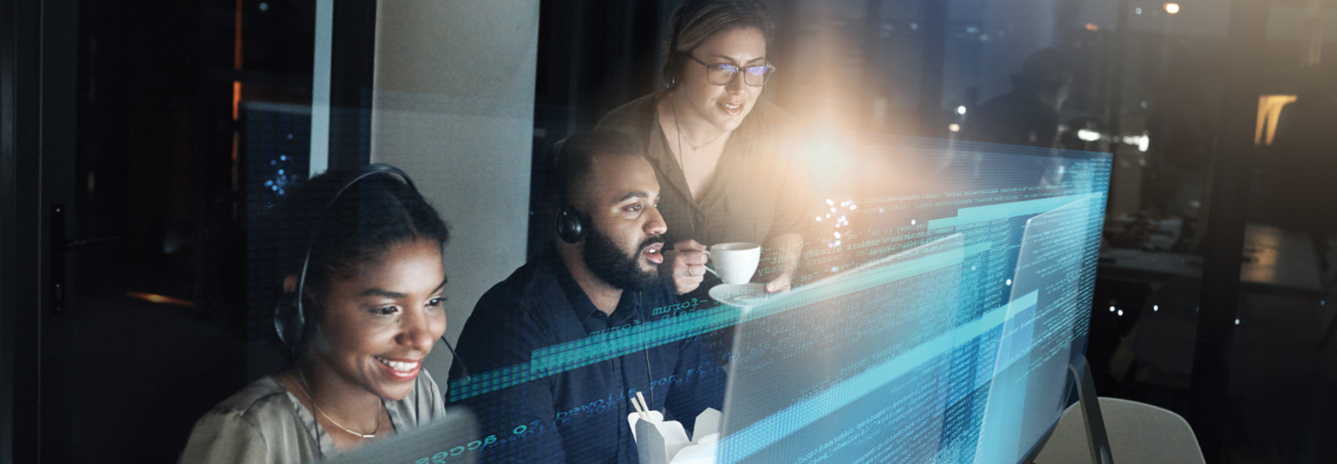 IT Help Desk image of three people working on computers 