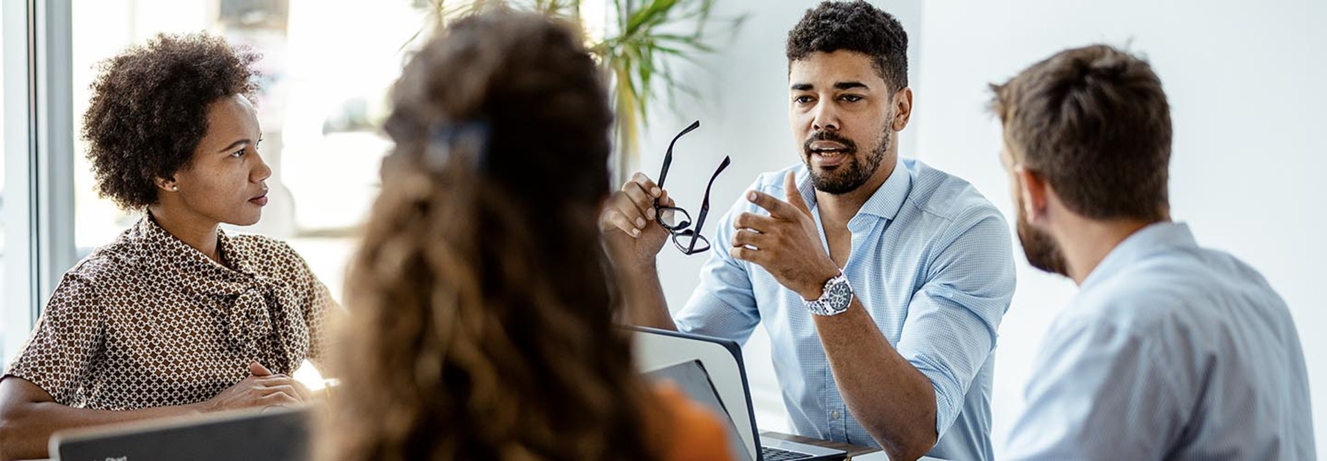 A group of people have a conversation around a table