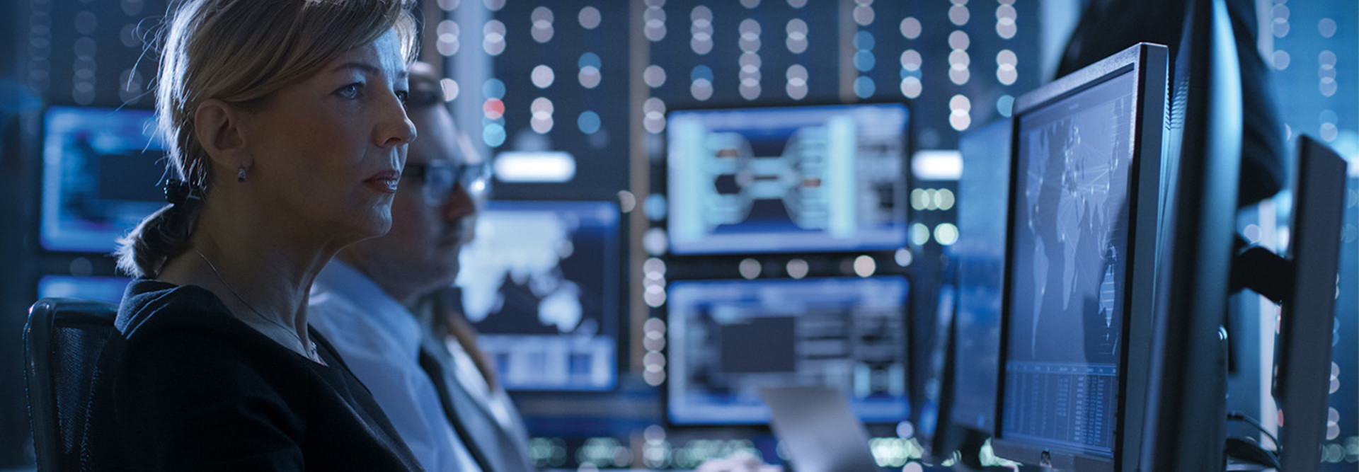 women watches monitor in mission-critical center
