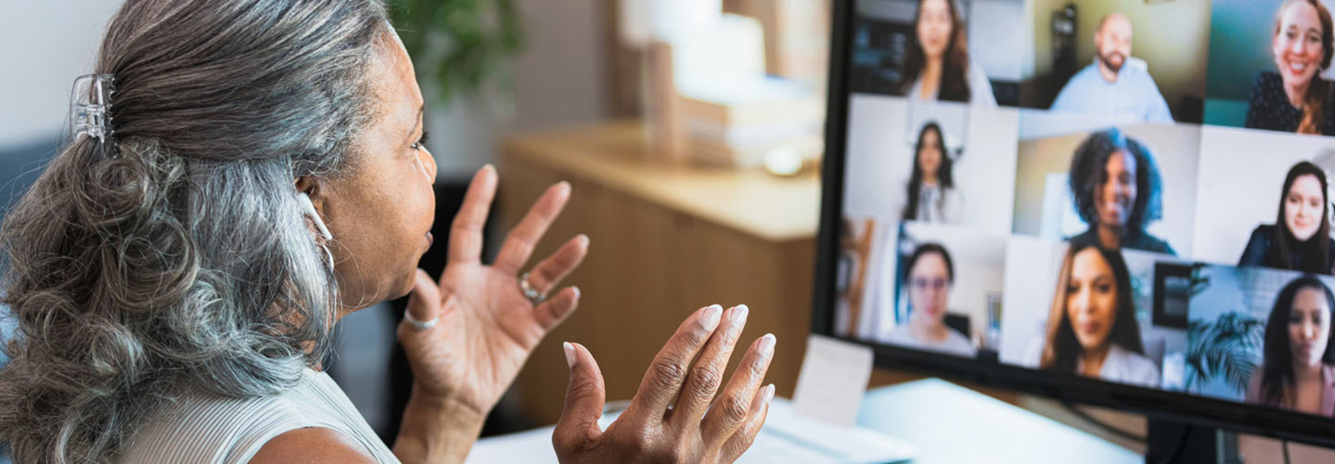 Woman sitting at computer teleworking.