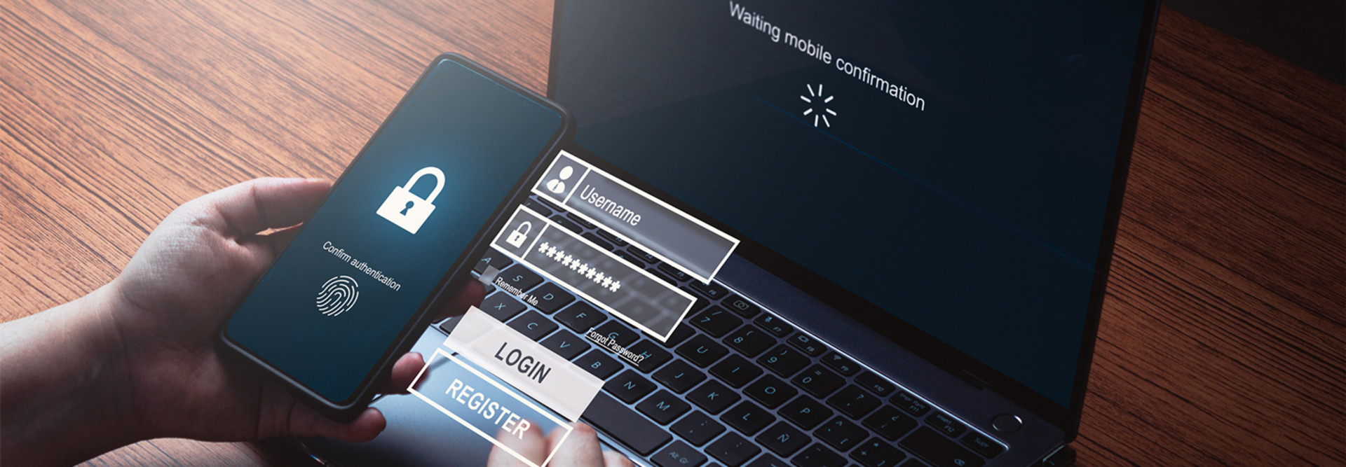 Person using smartphone to login waiting for scanner authentication on laptop.