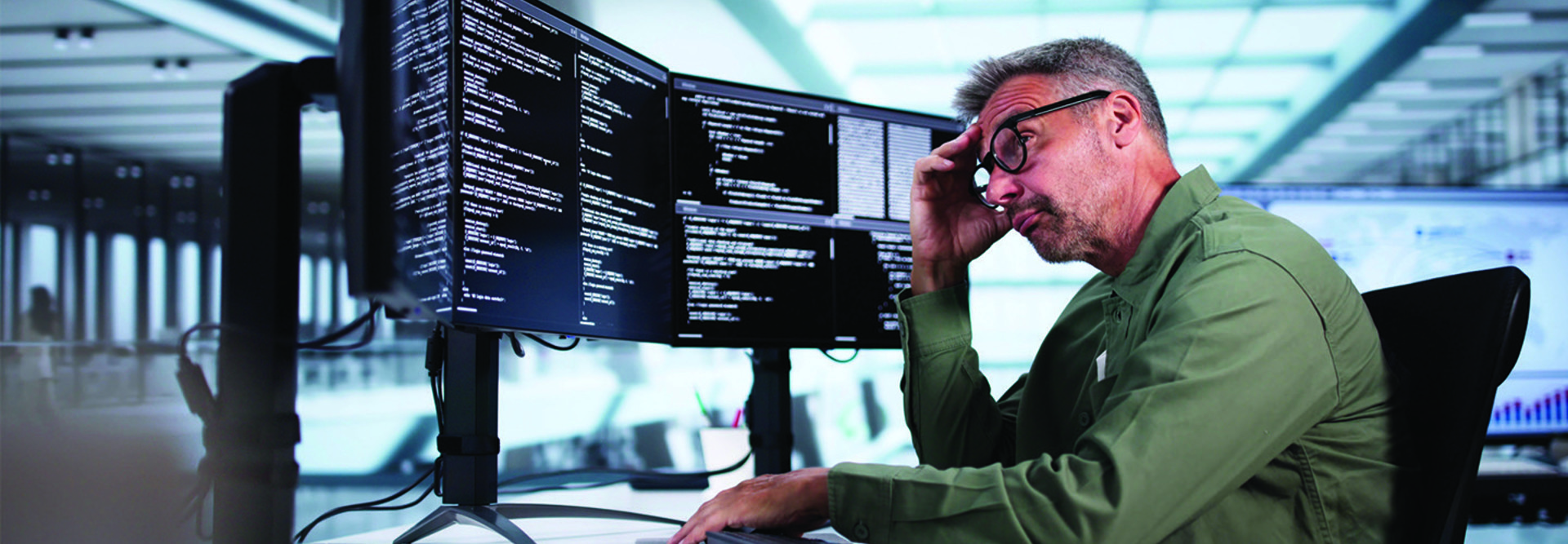 Man looking at coding on computer