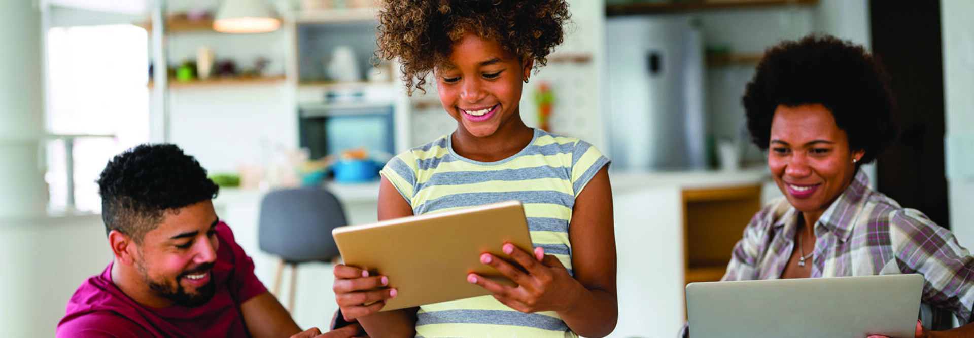 Family with laptop, tablet and smartphone
