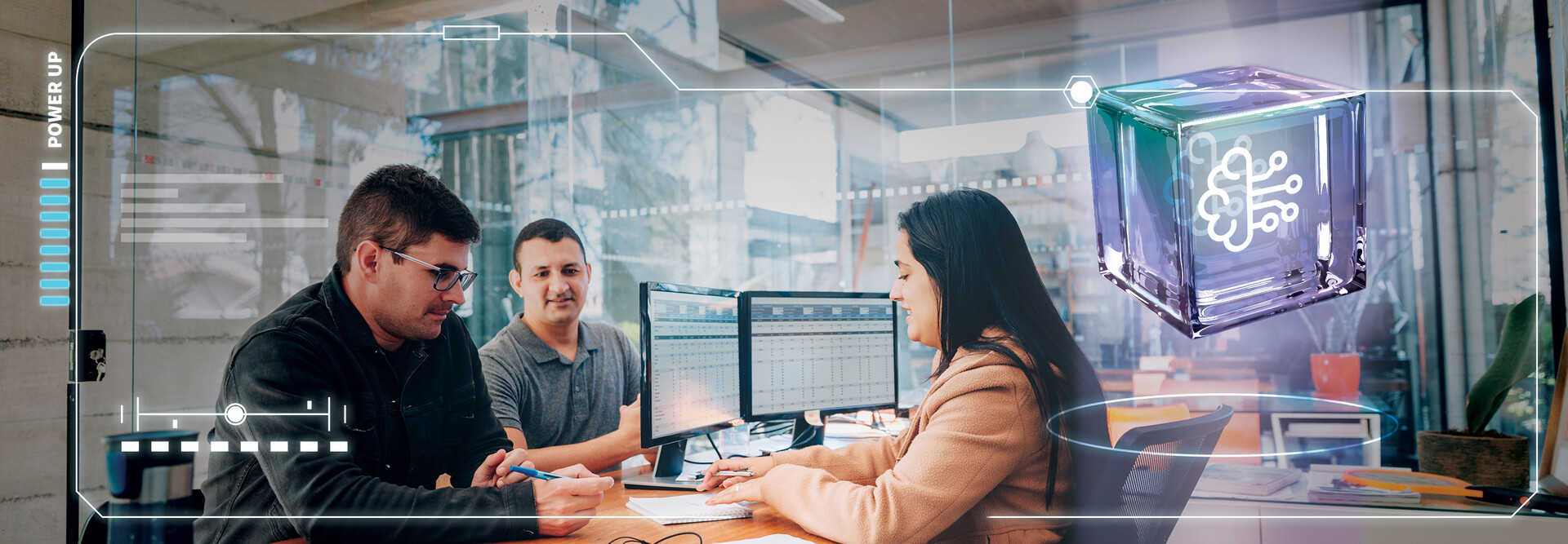 Three employees in front of a computer