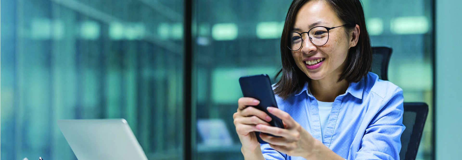 Person using smartphone at desk