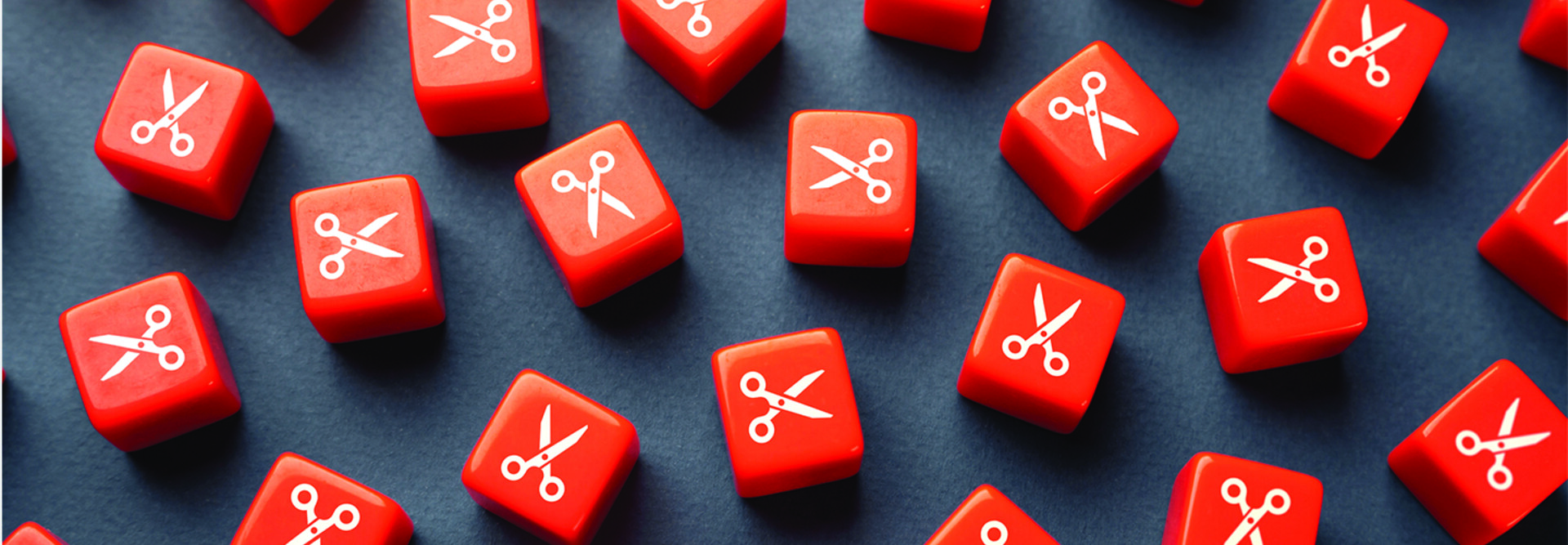Orange dice with scissors printed on them