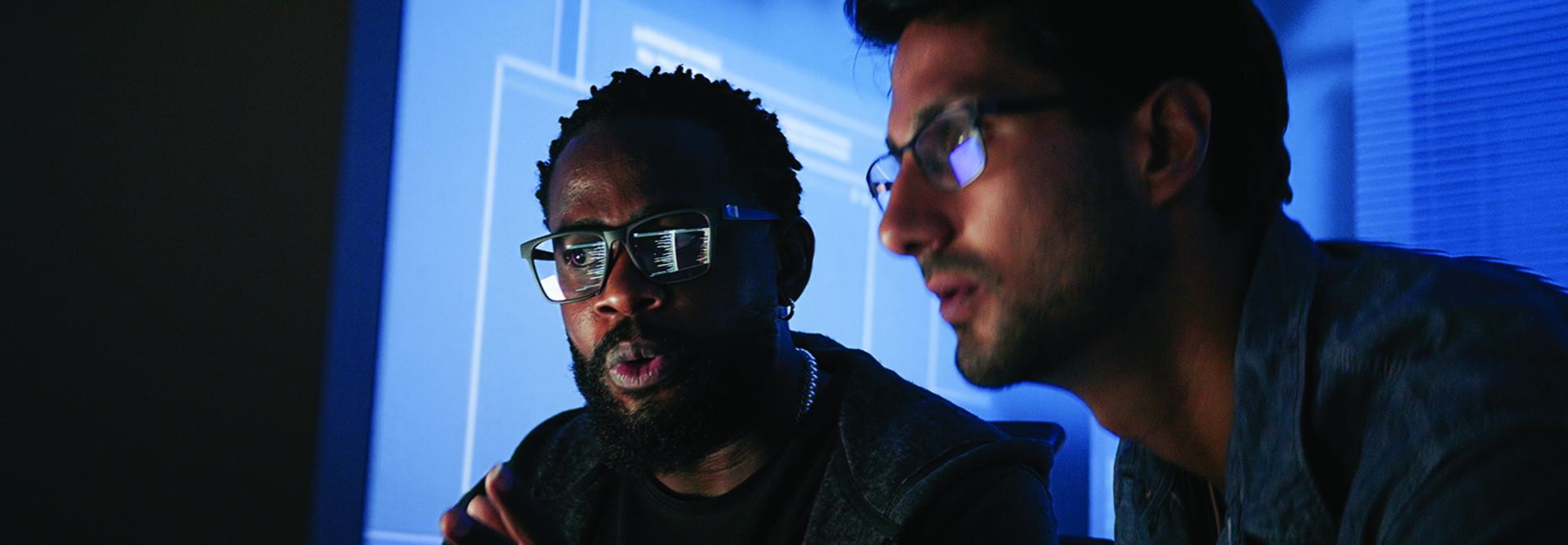Colleagues reviewing information on computer