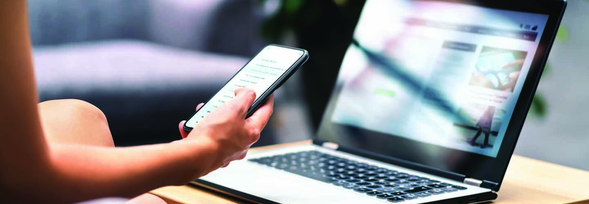 Person using phone and laptop