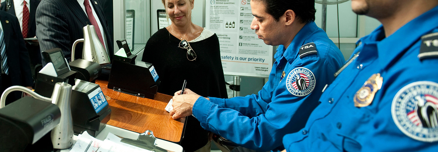 TSA officials checking passenger information