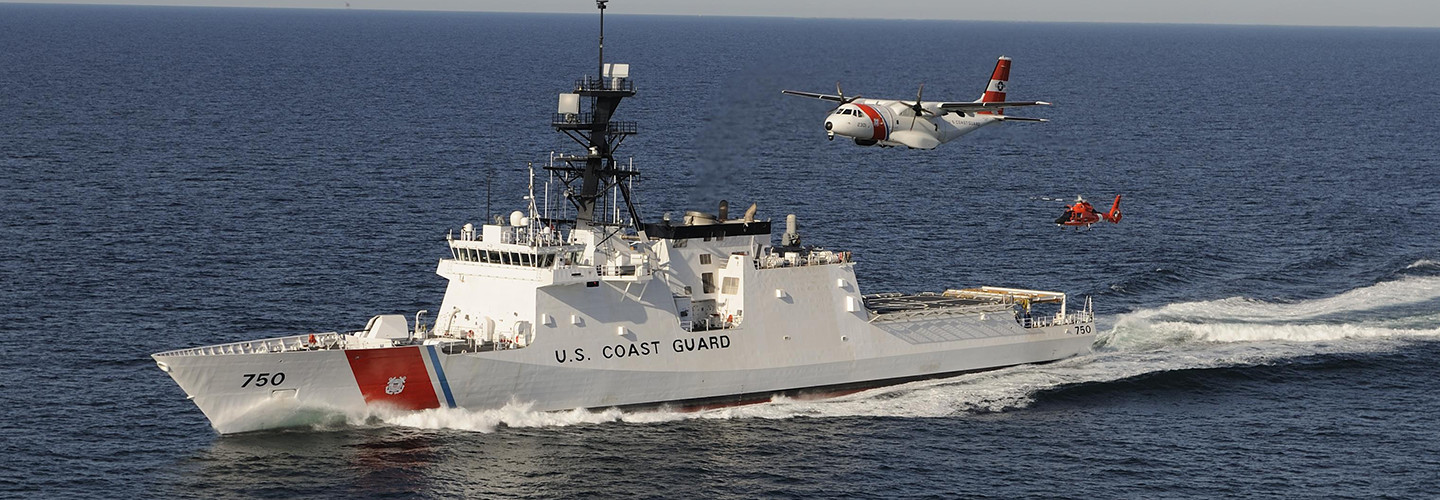 The U. S. Coast Guard's first national security cutter, the Bertholf, operating in concert an HC-144 maritime patrol aircraft and an MH-65 helicopter.