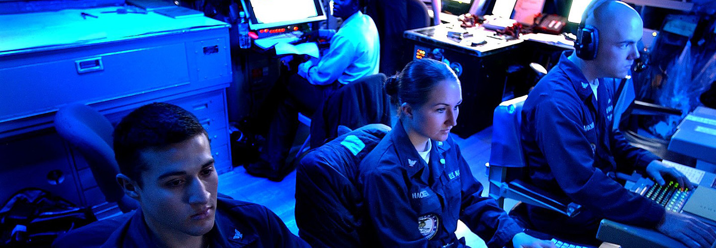 Operations Specialist’s 3rd Class Joseph Quintana, left, of Riverside, Calif., Sara Hacket, center, of San Jose, Calif., and Operations Specialist 2nd Class Ryan Archer of Sarasville, Ohio, monitor Global Command Control Systems (GCCS) in the Combat Direction Center (CDC) aboard the Nimitz-class aircraft carrier USS John C. Stennis 