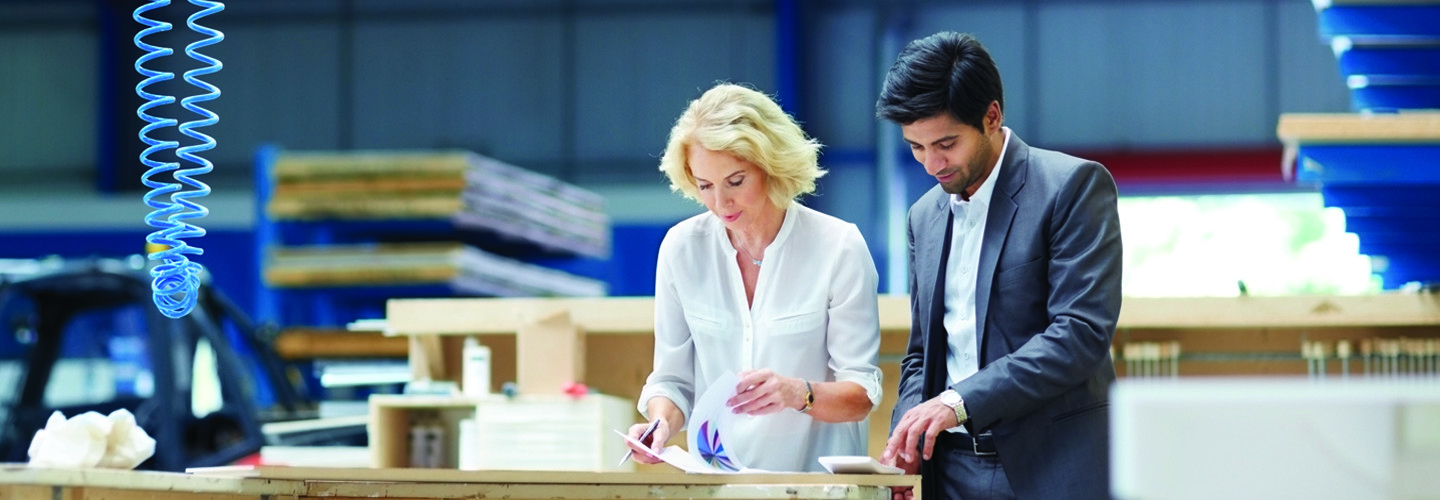 Man and woman looking at paperwork in a warehouse