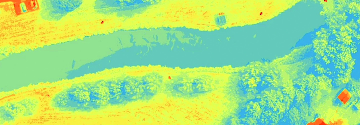 aerial imagery of a narrow pond tinted yellow and blue