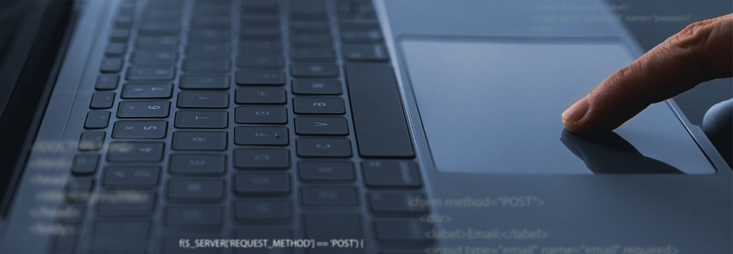 A software developer codes on a laptop