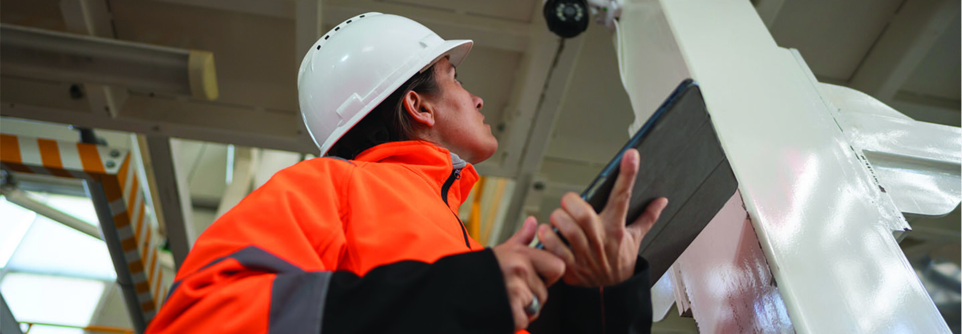 Factory worker inspecting camera