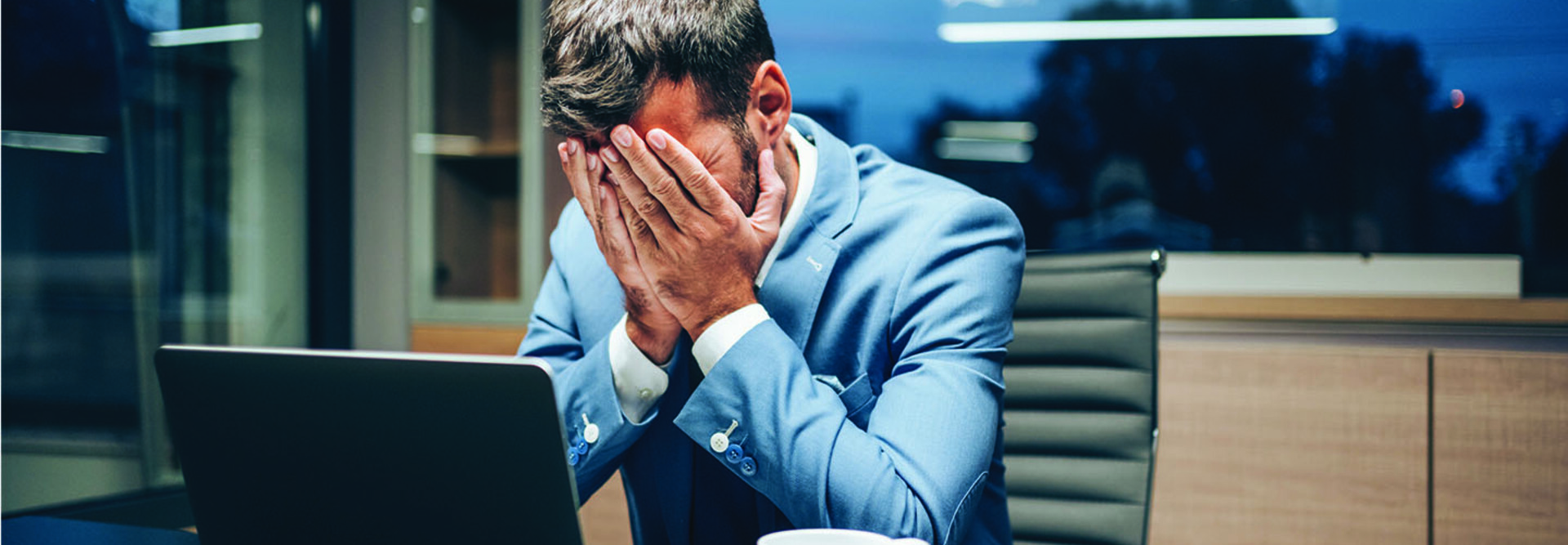 Employee with head in hands