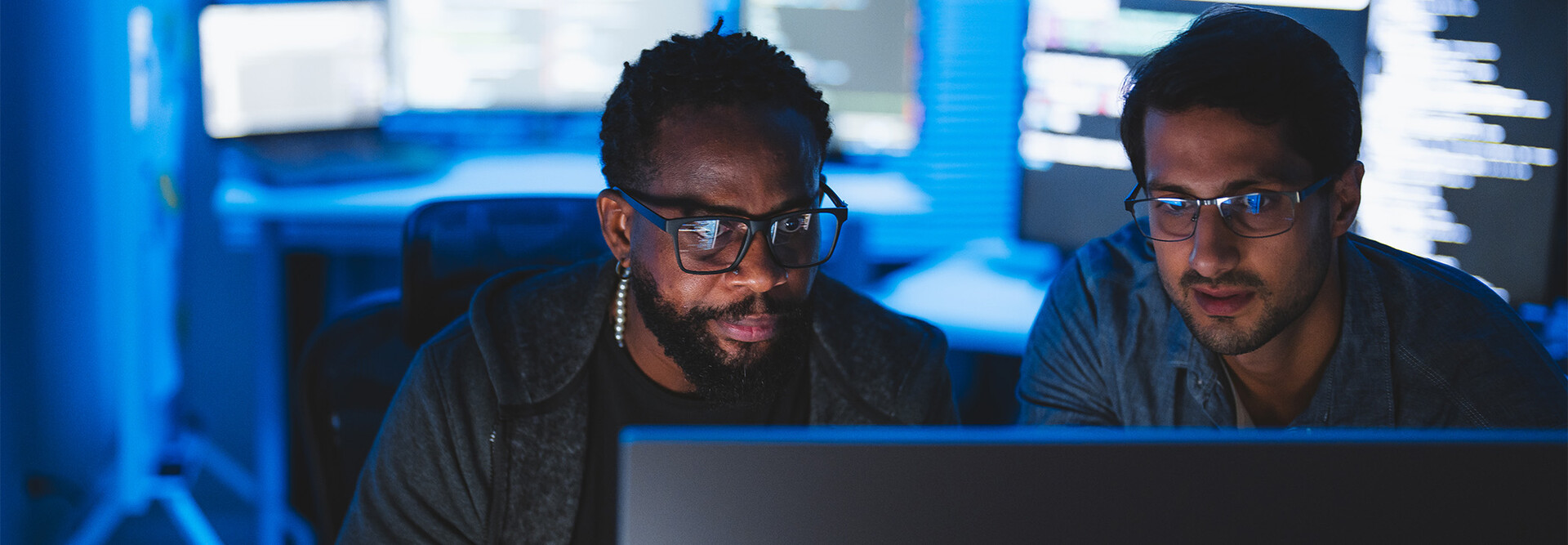 Two men looking at computer screen