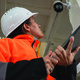 Factory worker inspecting camera