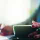 Lady writing with cup of coffee