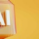Artificial Intelligence symbol in front of layered and twisted glass squares on orange background
