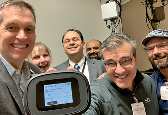 Dr. Thomas Osborne, left, and team celebrate after establishing their first 5G signal in February 2020.