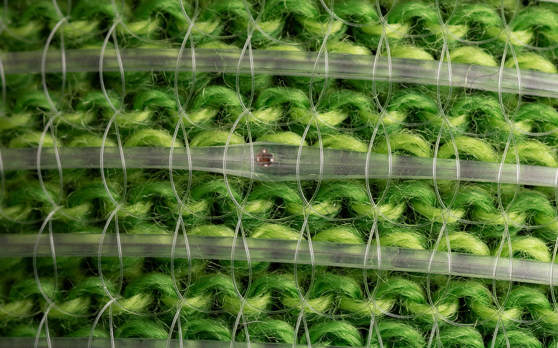 A close-up photograph of the digital fibers on green fabric.