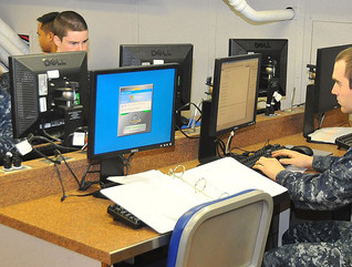 Sailors use computers in the Learning Media Resource Center to check personal email aboard the aircraft carrier USS Carl Vinson.