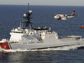 The U. S. Coast Guard's first national security cutter, the Bertholf, operating in concert an HC-144 maritime patrol aircraft and an MH-65 helicopter.