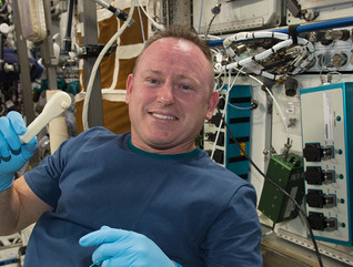 International Space Station Expedition 42 Commander Barry "Butch" Wilmore shows off a ratchet wrench made with a 3D printer on the station.