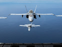 Four F/A-18C Hornets assigned to Marine Fighter Attack Squadron 323 fly in formation behind a KC-130J Super Hercules attached to Marine Aerial Refueler Transport Squadron 352, Marine Aircraft Group 11, during a readiness exercise called the ‘Elephant Walk’ above Marine Corps Air Station Miramar, Calif., Feb. 1, 2019.