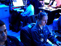 Operations Specialist’s 3rd Class Joseph Quintana, left, of Riverside, Calif., Sara Hacket, center, of San Jose, Calif., and Operations Specialist 2nd Class Ryan Archer of Sarasville, Ohio, monitor Global Command Control Systems (GCCS) in the Combat Direction Center (CDC) aboard the Nimitz-class aircraft carrier USS John C. Stennis 