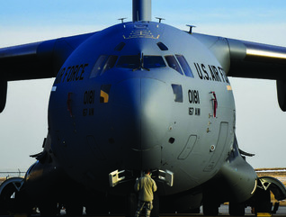 C-17 Globemaster III sits on a flightline; nose points towards camera