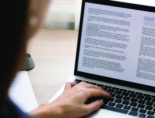 woman typing on laptop
