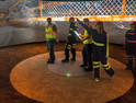 Research Lead Jennica Bellanca guides NIOSH workers through a virtual scenario on how to safely escape from a mine emergency. Each worker has a controller to operate the VR; the captain’s navigates them through the exercise. At left, what the 360-degree space looks like without VR.