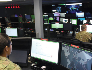 Sgt. Marisa Tortolano, a cyber operations specialist assigned to the 780th Military Intelligence Brigade, stands in the watch officer position of the Joint Mission Operations Center.