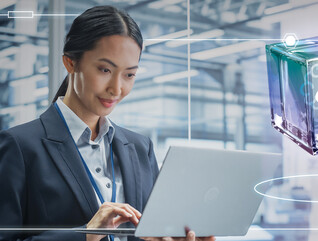 Person using laptop in a data center
