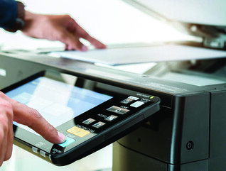 Person using a printer in the office