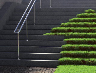 A grassy arrow pointing up concrete stairs
