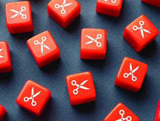 Orange dice with scissors printed on them