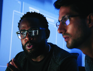Colleagues reviewing information on computer