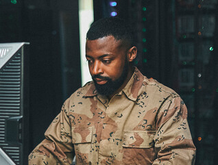 Soldier working on computer
