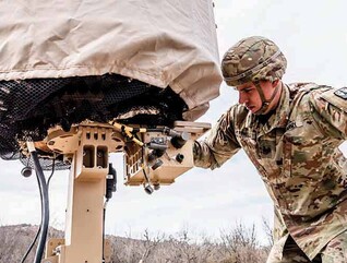 Military member using tech in the field